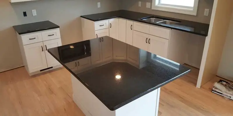 Black Pearl with White Cabinets and wood flooring